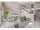 Bright living room with a staircase, neutral walls, tile floor, and cozy sectional at 3800 Bal Harbor Blvd # 415, Punta Gorda, FL 33950