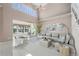 Bright living room with neutral walls, tile flooring, and waterfront views through sliding glass doors at 3800 Bal Harbor Blvd # 415, Punta Gorda, FL 33950