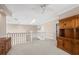 Spacious loft area with carpet flooring, railing, and built in shelving at 3800 Bal Harbor Blvd # 415, Punta Gorda, FL 33950