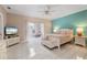 Inviting main bedroom with tile floors, ceiling fan, and a view of an outdoor patio at 3800 Bal Harbor Blvd # 415, Punta Gorda, FL 33950