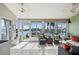 Bright sunroom featuring tiled floors, ceiling fans, and large windows overlooking the waterfront at 3800 Bal Harbor Blvd # 415, Punta Gorda, FL 33950