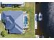 Overhead view highlighting the home's lanai, pool, and boat dock with a boat along the serene waterway at 3907 San Pietro Ct, Punta Gorda, FL 33950