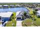 Aerial view of waterfront property with lush landscaping, boat dock, and tile roof at 3907 San Pietro Ct, Punta Gorda, FL 33950