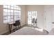 Bright bedroom with a desk by a window, complemented by a glass slider that leads to outdoor amenities at 3907 San Pietro Ct, Punta Gorda, FL 33950