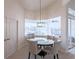 Bright dining area featuring a round glass table with seating, complemented by large windows offering outdoor views at 3907 San Pietro Ct, Punta Gorda, FL 33950