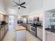 Well-lit kitchen featuring stainless steel appliances, island, and granite countertops at 3907 San Pietro Ct, Punta Gorda, FL 33950