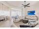 Comfortable living room with plush seating, large TV, and seamless access to outdoor spaces at 3907 San Pietro Ct, Punta Gorda, FL 33950
