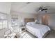 Spacious main bedroom features natural light from windows and a ceiling fan, creating a cozy and inviting atmosphere at 3907 San Pietro Ct, Punta Gorda, FL 33950