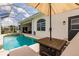 Relaxing pool and patio area with table, chairs and screened enclosure for comfortable outdoor living at 3907 San Pietro Ct, Punta Gorda, FL 33950