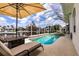 Gorgeous pool area featuring a screened lanai, lounge chairs, and stunning waterfront views at 3907 San Pietro Ct, Punta Gorda, FL 33950
