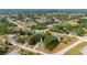 Aerial view of a neighborhood showcasing a home with mature landscaping, a metal roof, and easy access to the water at 4009 Yucatan Cir, Port Charlotte, FL 33948