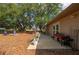 Backyard features a covered patio and landscaping; the perfect place to entertain outdoors at 4009 Yucatan Cir, Port Charlotte, FL 33948