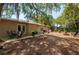 Beautiful backyard featuring a patio area, a fire pit, and mature trees, ideal for outdoor entertaining and relaxation at 4009 Yucatan Cir, Port Charlotte, FL 33948