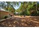 Expansive backyard with lush landscaping, a fire pit, and plenty of space for recreation and relaxation at 4009 Yucatan Cir, Port Charlotte, FL 33948