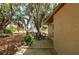 Inviting backyard with a patio and mature trees, offering a peaceful and private outdoor living space at 4009 Yucatan Cir, Port Charlotte, FL 33948