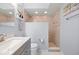 Bright bathroom featuring a tiled shower with glass partition, modern vanity, and marble-look floors at 4009 Yucatan Cir, Port Charlotte, FL 33948