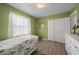 Comfortable bedroom with hardwood floors, leafy green walls, a ceiling fan, and natural light at 4009 Yucatan Cir, Port Charlotte, FL 33948