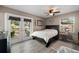 Bedroom with backyard access through French doors, a ceiling fan, and a cozy decor at 4009 Yucatan Cir, Port Charlotte, FL 33948
