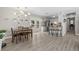 Dining area showcasing new floors, open layout and seating with view of fenced backyard at 4009 Yucatan Cir, Port Charlotte, FL 33948