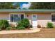 Inviting front entrance with beautiful landscaping and decorative accents at 4009 Yucatan Cir, Port Charlotte, FL 33948