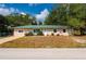 Beautiful single-story home featuring a vibrant garden and a lush green lawn at 4009 Yucatan Cir, Port Charlotte, FL 33948