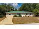 Well-manicured front yard with lush flowerbeds and landscaping, enhancing the home's curb appeal at 4009 Yucatan Cir, Port Charlotte, FL 33948