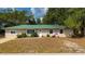Charming home featuring a well-maintained front yard with vibrant flowerbeds and landscaping at 4009 Yucatan Cir, Port Charlotte, FL 33948