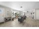 Bright living room featuring wood floors, large windows, and a decorative plant stand at 4009 Yucatan Cir, Port Charlotte, FL 33948