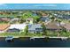 Stunning aerial view of waterfront homes featuring docks, pools and lush landscaping on a sunny day at 5010 La Costa Island Ct, Punta Gorda, FL 33950