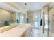 Bathroom with double vanity, glass vessel sinks, and a glass door shower at 5010 La Costa Island Ct, Punta Gorda, FL 33950