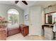 Bathroom featuring an arched window, tile floors, wooden cabinets and a granite countertop at 5010 La Costa Island Ct, Punta Gorda, FL 33950