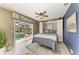 Bedroom featuring a Murphy bed, fan and sliding glass doors leading to a pool at 5010 La Costa Island Ct, Punta Gorda, FL 33950