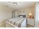 Bright bedroom features a ceiling fan, natural light and comfortable striped bedding at 5010 La Costa Island Ct, Punta Gorda, FL 33950