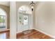 Elegant foyer with hardwood floors, stylish lighting, and decorative glass door at 5010 La Costa Island Ct, Punta Gorda, FL 33950