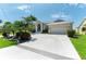 Home featuring manicured landscaping, circular driveway and covered entrance at 5010 La Costa Island Ct, Punta Gorda, FL 33950