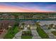 Stunning waterfront home with lush landscaping, circular driveway, and boat access at sunset at 5010 La Costa Island Ct, Punta Gorda, FL 33950