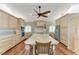 Contemporary kitchen with light wood cabinets, tile backsplash, a large central island, and hardwood floors at 5010 La Costa Island Ct, Punta Gorda, FL 33950