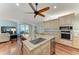 Kitchen island sink with bar seating, wood floors, and stainless steel appliances at 5010 La Costa Island Ct, Punta Gorda, FL 33950