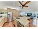 Modern kitchen with stainless steel appliances, granite countertops, a kitchen island, and wood floors at 5010 La Costa Island Ct, Punta Gorda, FL 33950