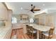 Spacious kitchen with wood floors, granite countertops, an island with bar seating, and stainless steel appliances at 5010 La Costa Island Ct, Punta Gorda, FL 33950
