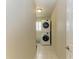 Efficient laundry room with stacked washer and dryer and tiled flooring at 5010 La Costa Island Ct, Punta Gorda, FL 33950