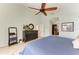 Beautifully lit main bedroom with tiled floors, a ceiling fan, a dresser, and access to the ensuite at 5010 La Costa Island Ct, Punta Gorda, FL 33950