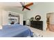 Well-lit main bedroom with tiled floors, ceiling fan, and sliding glass door to the pool and patio area at 5010 La Costa Island Ct, Punta Gorda, FL 33950