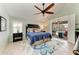 Bright main bedroom with tiled floors, ceiling fan, and a sliding glass door to screened-in patio at 5010 La Costa Island Ct, Punta Gorda, FL 33950