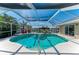 Inviting screened-in pool and spa area with views of the surrounding waterway at 5010 La Costa Island Ct, Punta Gorda, FL 33950