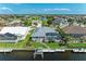 Waterfront home featuring a screened-in pool, boat dock, and lush green lawn at 5010 La Costa Island Ct, Punta Gorda, FL 33950