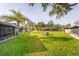 Spacious backyard features a lush lawn with mature landscaping and well-maintained homes at 5301 Linksman Pl, North Port, FL 34287