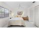 Cozy bedroom with natural light, ceiling fan, and a spacious closet at 5301 Linksman Pl, North Port, FL 34287