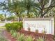 Entrance sign to Fairway Villas, surrounded by lush landscaping at 5301 Linksman Pl, North Port, FL 34287