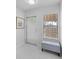 Bright entryway with tile flooring, modern bench, and natural light at 5301 Linksman Pl, North Port, FL 34287